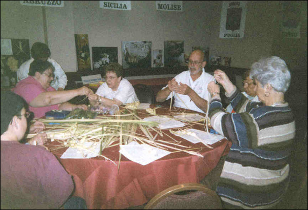 Anna Marie Fiori (second from left) and Gene Fedeli (third from right) teach participants to weave p